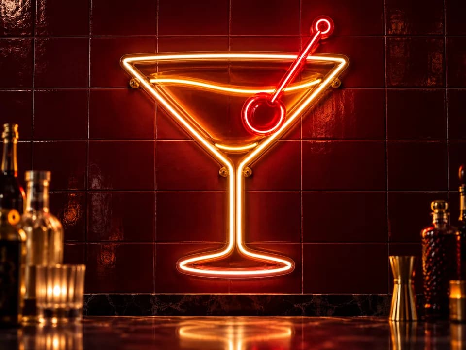 Design preview of an amber and ruby-red cocktail neon sign in a dark bar