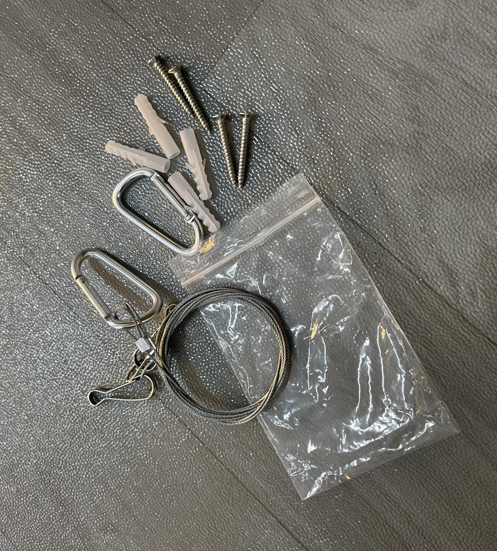 Unpacked hanging kit accessories with chain, ring buckles, screws and anchors